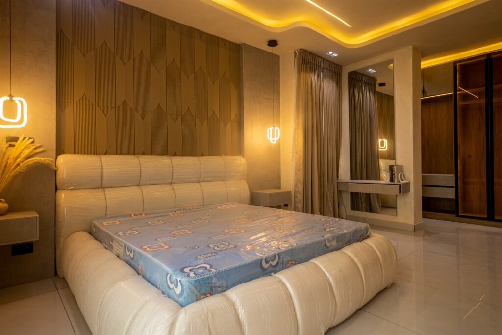 Brum Height 9: Bedroom with an upholstered bed and wood-panelled headboard wall